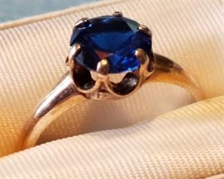 Vintage size 6 lady's ring with beautiful dark blue 2 carat (approximately) stone that flashes red and blue highlights in the light. Possibly a tanzanite or amethyst (?) but we are not gemologists so cannot be sure. Please see photo of test results from a Presidium Colored Stone Gem Tester in item description on auction website.