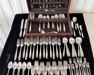 102 piece set of sterling silver flatware by International in the Prelude pattern, introduced in 1939, no monograms. Total avoir weight (including non silver knife blades) is approximately 4,160 grams. Includes: (14) 9" knives, (14) 7 1/4" forks, (14) Ice Teaspoons, (16) teaspoons, (10) 6 1/2" soup spoons, (12), 6 1/2" salad forks, (11) cocktail forks, (3) 8 1/2" serving spooons, (2) individual butter knives, PLUS master butter knife, demitasse spoon, 8 1/2" slotted serving spoon, 9" serving fork, 6" ladle, and sugar spoon.