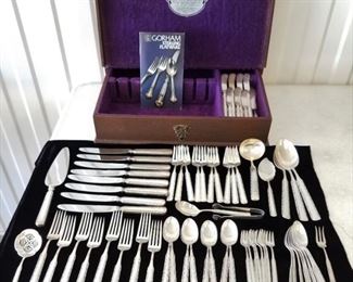 59 piece set for eight plus extras and serving pieces in the "Eventide" pattern by Gorham Silver Company. No monograms. Total avoir weight including non silver knife blades is approximately 2770 grams. Pattern was introduced in 1936. Set includes 8 each of 7 1/8" forks, teaspoons, iced teaspoons, cocktail forks, and 8 3/4" knives PLUS ten 6 1/2" salad forks, three 8 1/2" serving spoons, master butter knife & 7 flat butter knives, ladle, sugar shell, pickle fork, bonbon/nut spoon, jelly slice, sugar tongs, and pie server.