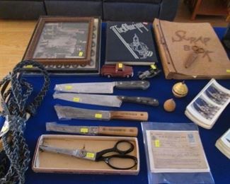 Our "Older Treasures Table".  Tops, Metal Trucks, Photos, Scrapbook, Annuals + Wiss Pinking Shears, Model A and Old Hickory & Henckels Knives and a Vintage Whip!