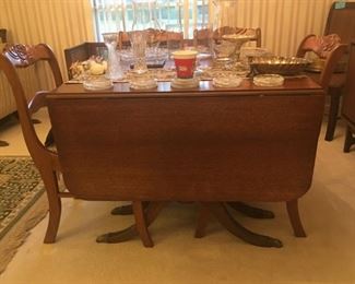 Duncan Phyfe style, drop leaf table with six chairs and leaf.