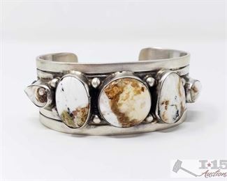 277: Bobby Johnson White Buffalo Freeform Row Wide Sterling Cuff, 81.5g
Sterling Silver | Genuine White Buffalo | Bobby Johnson White Buffalo Freeform Row Wide Cuff Bracelet | Navajo Native American Southwest Indian Jewelry | Dimensions: Bracelet: 5.5" inner, 1.25" gap, 6.75" total, 1" face width, .75" diameter center stone | Signed: B Johnson, Weighs approx 81.5g
Metal Type: Sterling Silver
Low Estimate: 600
High Estimate: 800