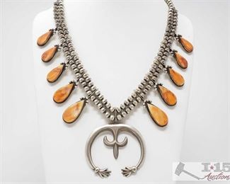 310:
Navajo Orange Spiny Squash Necklace Signed By Selena Warner, 99.3g,
Orange Spiny Oyster and Sterling Silver Squash Necklace. Handmade by the Artist Selena Warner. Measuring approx 26 inches long with a 2 inch wide Naja. Beautiful piece for your summer wardrobe.
Sterling Silver Necklace weighs approx. 99.3g