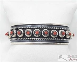 322:
Navajo Coral & Sterling Silver Snake Eye Cuff Bracelet Signed And Stamped, 36.7g
This is a beautiful handmade Navajo Coral and Sterling Silver snake eye Cuff Bracelet. This piece measures 3/4 of an inch wide. The inside circumference is right a 5 1/2 inches with a gap of 1 1/4 inches. This piece is signed by the artist and stamped Sterling. Weighs approx 36.7g