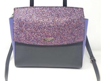 901:
Kate Spade Hand Bag
What a gorgeous new leather Kate Spade purse! This one is gray with lavender sides, glitter accent, and solid black front and back sections with black handle and shoulder strap. VERY nice!!