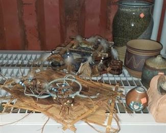 6625: Various native decor
Native American home décor! Handmade pieces include a beautiful blue feather dream catcher, a pottery incense bowl, some jewelry pieces, antelope wall hangings, terra cotta candle holder, two small pots, a very decorative drum flask, and more!