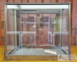 6643:
Antique Wood and Glass Display Case
This item is an antique wooden framed glass display case, flush flat back with sliding door and an arched front face. Ready for clean-up and repurposing!