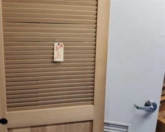 6644: Two Wooden Doors
Shown here are two interior wooden doors. The natural wood door with missing hardware has vented upper slats ideal for closet space enclosures. The lockable white door serves a utility function with uninterrupted air flow through the lower section.
