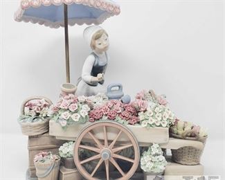 8501: Lladro "Flowers of the Season"
Lladro’s “Flowers of the Season” figurine is a glossy porcelain sculpture of a woman selling flowers with lots of pots, boxes, and baskets full. Protecting her from the sun is a large umbrella with birds perched upon it. Very unique and beautiful! This piece is missing some flowers and a bird. Measures approx 11" tall and wide.
Low Estimate: 1600
High Estimate: 3500