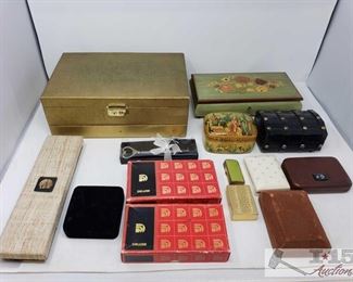 8550: Various Jewelry Boxes, Pins, Chop Sticks, And More!!
Shown here, several boxes containing several miscellaneous pieces of costume jewelry, pins, silver achievement bars, key box, jewelry boxes, check case covers, and much more!