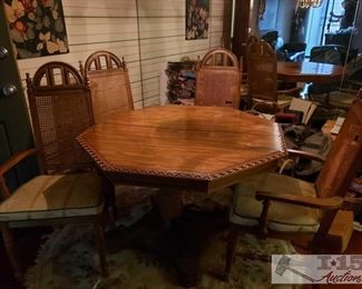 8600: Octagon Shaped Dining Room Table with 4 Chairs
EXCEPTIONALLY GORGEOUS!! This Octagon shaped table with carved heart shaped lattice edges sits on a sturdy pedestal with four-point base anchored in decorative bended belts of wrought iron. Accompanied by four tall-back caned chairs, exquisitely detailed with cathedral window style splay upper back and rounded spindles on each end. Seats are wide, covered in beige fabric with gold and gray accents, green piping. Pretty unique and special! Table measures approx 44" x 30"