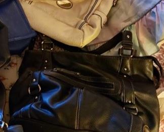 8714:
Approximately 11 Various Handbags
Roughly 11 various handbags mostly in black leather in different sizes. All look to be gently used and in good condition.