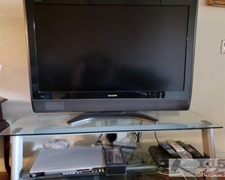 8853:
45" Sharp TV, DVD Player, Dish Reciever, TV Stand and More
Three electronic items you need for your entertainment room:
* a Sharp 45” television model number LC-45D40U 52" x 22" x 21"
* an AStar 6800 DVD player features full compatibility with DVD, CD, Kodak Picture CD, CD-R, and CD-RW. Has multiple playback modes, dynamic spectrum display, and digital audio output.
* a Mitsubishi Hi Fi U52 4-head video cassette recorder with intelligent picture, twin digital tracking, and 200 index time search function
This lot includes a metal and glass stand for all three!