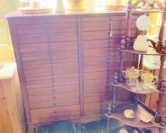 Cabinet with loads of drawers,( sheet music cabinet?) clock