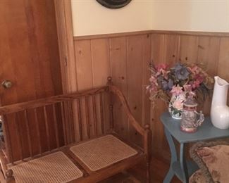 Wood bench with cane seats, little wood heart shaped table, wall clock