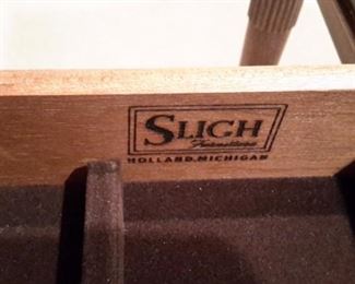 Rare Stunning Sligh Two-Tier English writing desk with leather top writing surface furniture of Holland, Michigan. The brass lock hardware accents the 9 drawers with original brass pulls. The curved back is beautifully finished so the desk can free-stand in a room. Lesser size listing as follows on another site...not same desk but same maker. https://www.1stdibs.com/furniture/tables/desks-writing-tables/sligh-walnut-curved-front-desk-leather-top/id-f_1141858/?gclid=Cj0KCQjwv8nqBRDGARIsAHfR9wCSzbjfRooPw17h1GRU9-mS9jtoJT_NI9xHfYXxVB7voUHKdIeTFxgaAhgsEALw_wcB&gclsrc=aw.ds