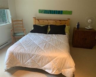 Queen size beds including this rustic pine one. Down comforters and other bedding throughout home.