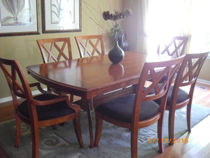 Basset dining room table with four chairs and two arm chairs.  Black fabric in good condition.  Table is wider than some and is 74" x 44".  Beautiful condition.