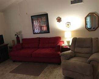 TWO SWIVEL EASY CHAIRS AND COMFORTABLE RED SOFA.