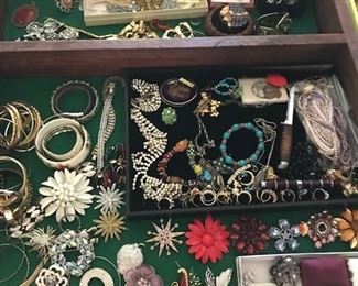 A large supply of costume jewelry. Broaches, rings, bracelets.