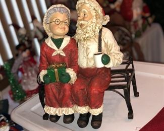Santa and Mrs. clause snuggling on a bench