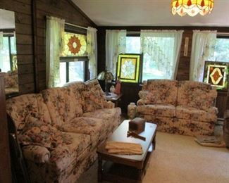 Sofa, loveseat, stained glass windows.