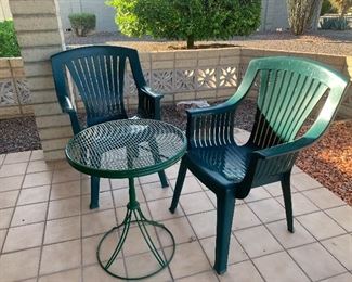 Plastic green chairs and small table