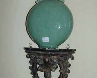 Carved wall shelf and porcelain vase