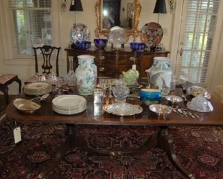 Sterling serving pieces and stacks of plates