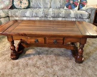 Early American coffee table with drop leaf sides.  Nice and solid.