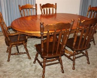 Beautiful solid oak pedestal dining table and chair (additional leaf not pictured).