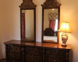 Ornate dresser with matching mirrors.