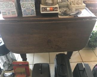 Featured here is an ancient drop leaf table that is still in great shape.  In the forefront are some early movie cameras