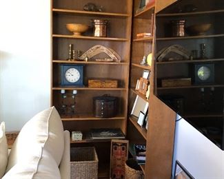 Bookcases for sale along with collectibles displayed on the shelves