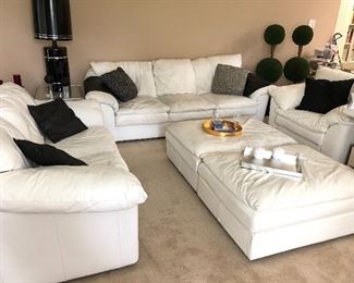 White leather couch, loveseat, chair and two ottomans