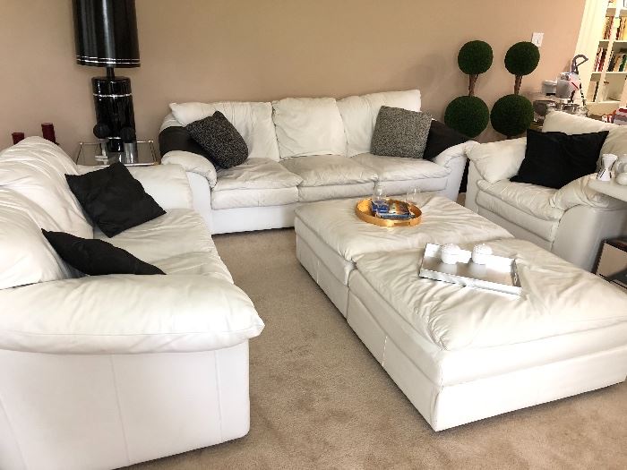 White leather couch, loveseat, chair and two ottomans