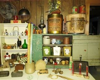 Vintage shelf, primitive green painted cupboard, Coffee Tins, wooden coffee basket, vintage plastic canister sets (3), metalware, Aladdin lamp, vintage crocks, antique fan & lamp, misc. glass & porcelain collectibles