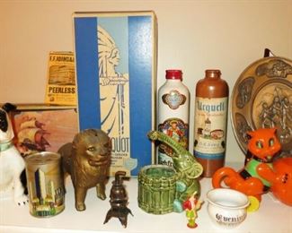 Collectible banks, vintage boxes, vintage plastic Halloween decor on wheels, stoneware liquor bottles, pewter 1976 plates, elephant planter