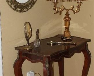 French Ladies’ Writing Desk with Ormolu Brass Mounts and Center Drawer. Also shown is a Vintage Italian Florentine 2 Arm Table Lamp and an Antique Gold Gilt Oval Framed Louis Icart “Le Bonnet Blue” Print