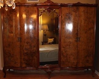 Antique French Burl Panel 5-Door Armoire w/ Mirrored Center Door. Removable shelves inside each of the closet sections (8’W x 6’7”H x 21”D)