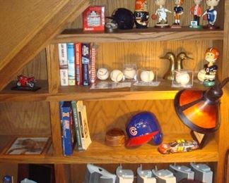 Shelf of some of the bobble heads and other items.