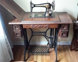 Antique Singer sewing machine and cabinet.