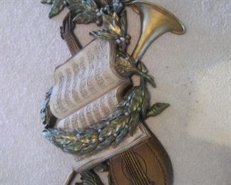 Decorative wall hanging with piece w/ trumpet, violin and holly. https://ctbids.com/#!/description/share/216847