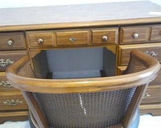 Desk with storage and wicker back chair.https://ctbids.com/#!/description/share/212880