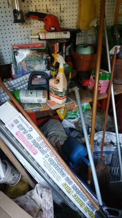 Garden shed with assortment of tools and garden equipment.