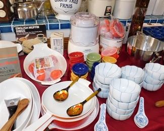 kitchen packed with cookware, kitchen gadgets, cook books, small appliances, pots and pans