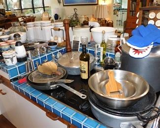 kitchen packed with cookware, kitchen gadgets, cook books, small appliances, pots and pans
