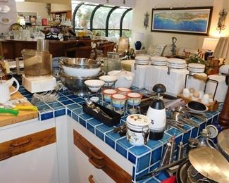 kitchen packed with cookware, kitchen gadgets, cook books, small appliances, pots and pans