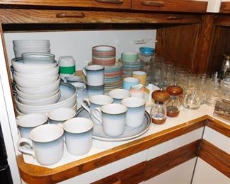 kitchen packed with cookware, kitchen gadgets, cook books, small appliances, pots and pans