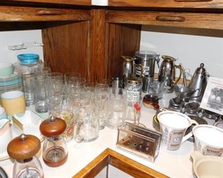 kitchen packed with cookware, kitchen gadgets, cook books, small appliances, pots and pans